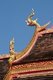 Thailand: Naga eaves on a brightly-coloured viharn in the grounds of Wat Phra That Lampang Luang, northern Thailand